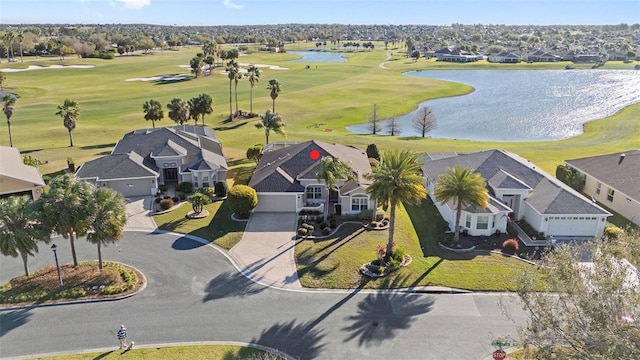 birds eye view of property with view of golf course, a water view, and a residential view