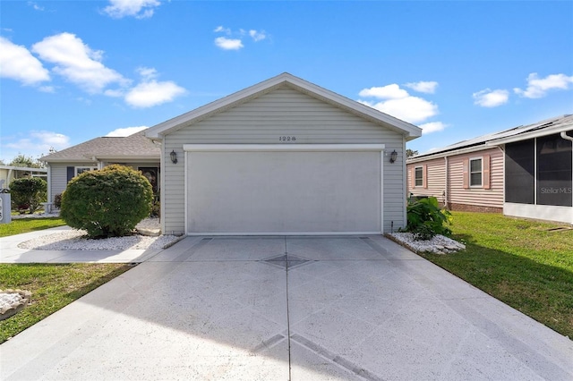 view of front of property with a garage and a front lawn