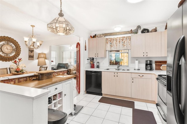 kitchen featuring stainless steel appliances, sink, decorative light fixtures, a notable chandelier, and light tile patterned flooring