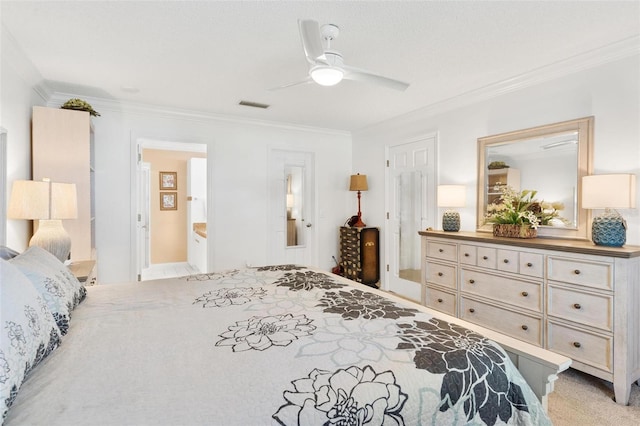 carpeted bedroom featuring ceiling fan, ornamental molding, and ensuite bath