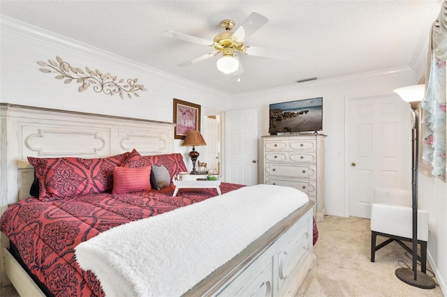 bedroom featuring light carpet, a textured ceiling, ceiling fan, and ornamental molding