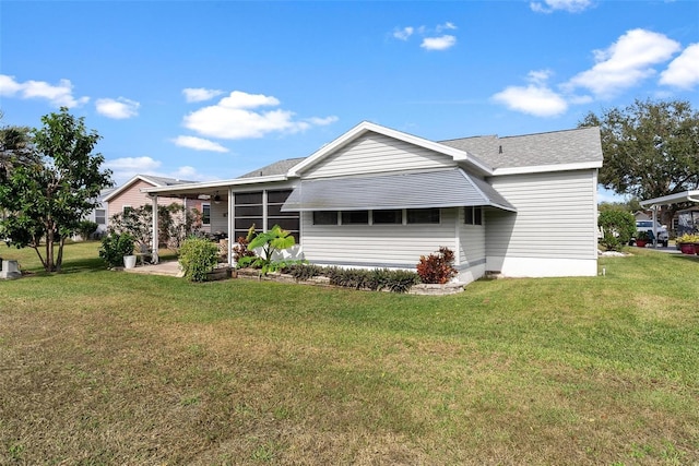 rear view of house with a yard