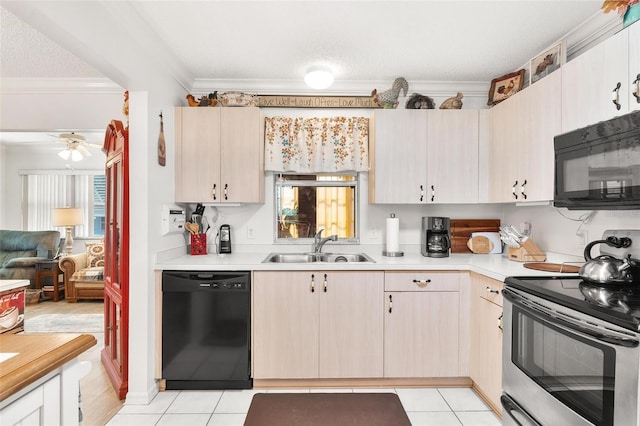 kitchen with ornamental molding, a sink, black appliances, light countertops, and a wealth of natural light
