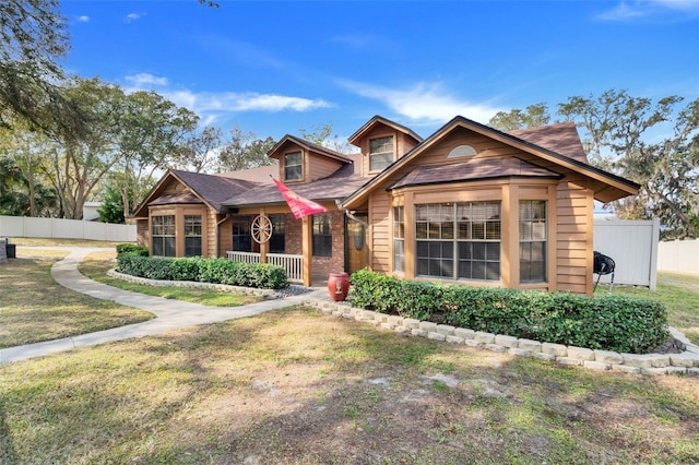 view of front of home featuring a front yard and covered porch