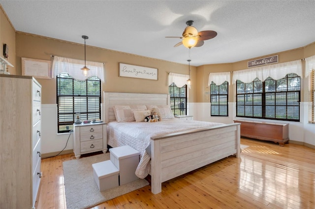 bedroom featuring a textured ceiling and light hardwood / wood-style floors