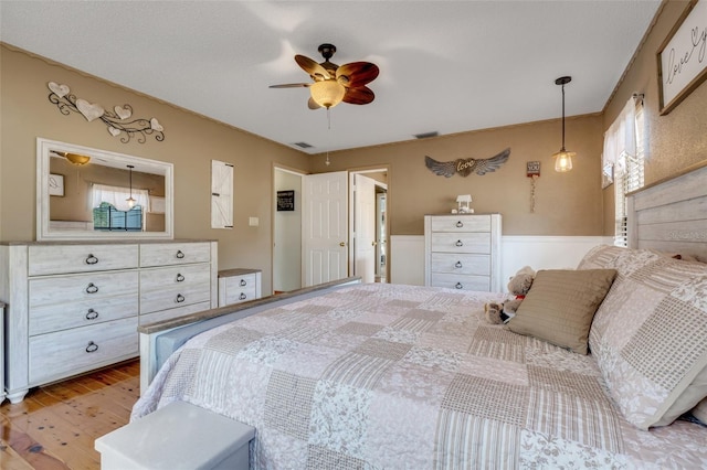 bedroom with hardwood / wood-style floors and ceiling fan