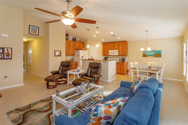 tiled living room featuring ceiling fan and vaulted ceiling