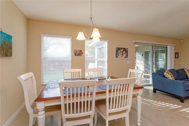 tiled dining area with an inviting chandelier