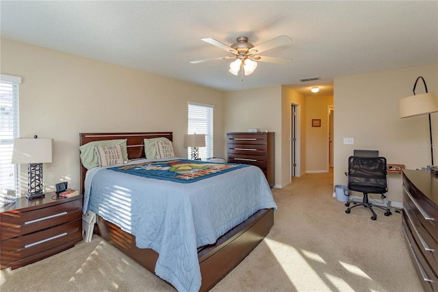 bedroom featuring light carpet and ceiling fan