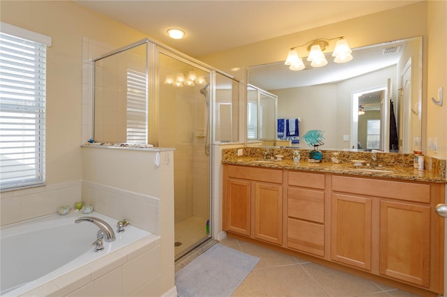 bathroom featuring shower with separate bathtub, vanity, and tile patterned floors