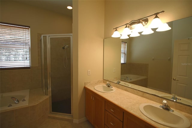 bathroom with tile patterned floors, separate shower and tub, and vanity