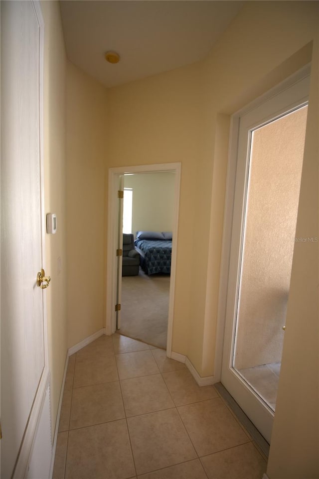 corridor with light tile patterned floors