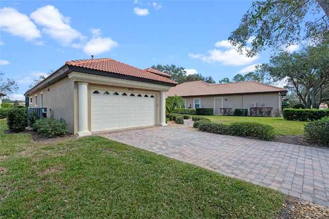 view of front of property with a garage and a front lawn