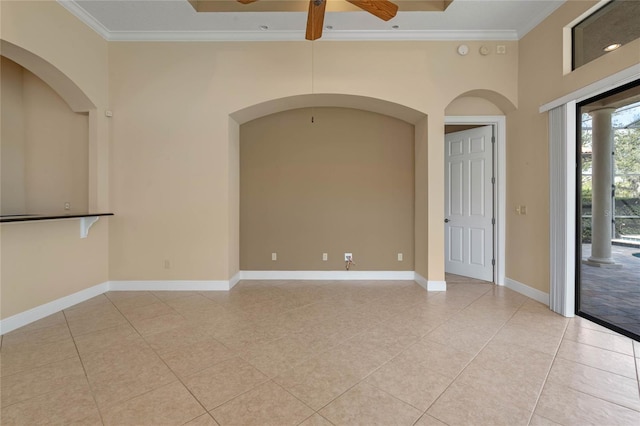 unfurnished room featuring light tile patterned floors, ornamental molding, ceiling fan, and a high ceiling