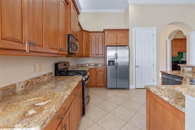 kitchen featuring crown molding, appliances with stainless steel finishes, light tile patterned floors, and light stone counters