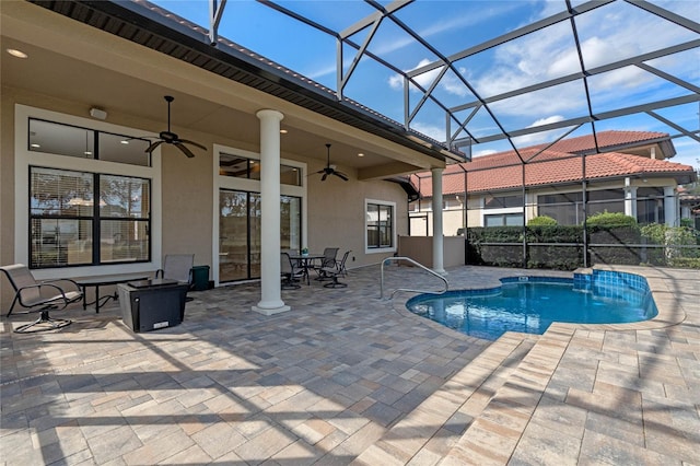 view of swimming pool featuring a lanai, ceiling fan, and a patio area