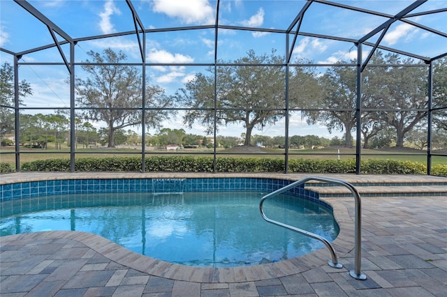 view of swimming pool with a patio and a lanai