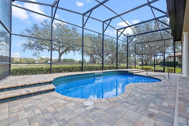 view of swimming pool with pool water feature, a patio area, and glass enclosure