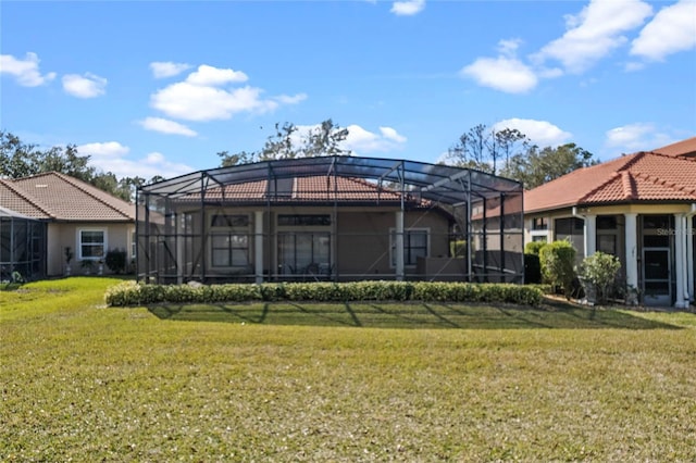 back of house featuring a yard and a lanai