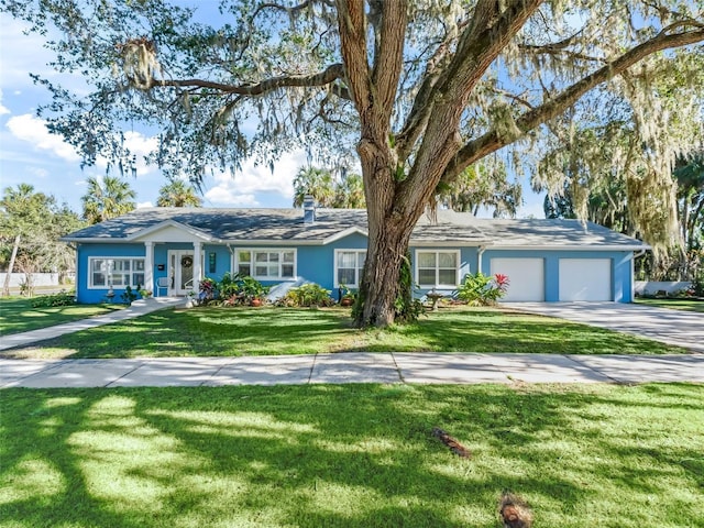 single story home with a front yard and a garage