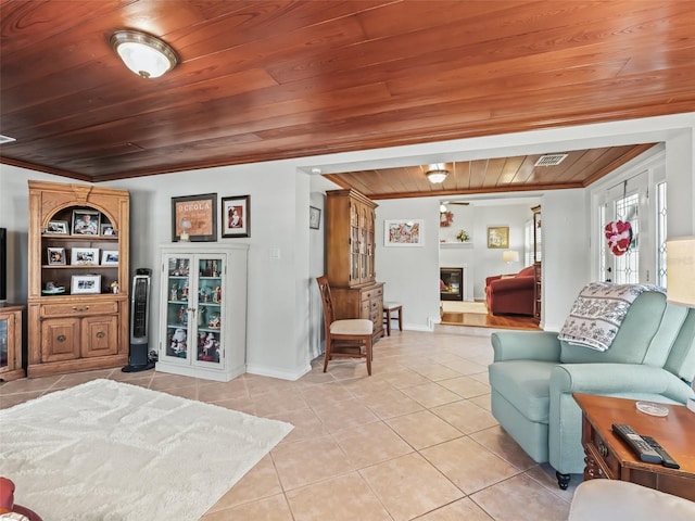 tiled living room with ornamental molding and wooden ceiling