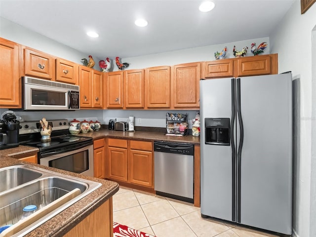 kitchen featuring sink, light tile patterned flooring, and stainless steel appliances