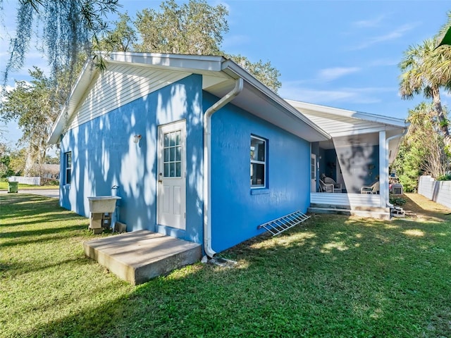 back of house featuring a lawn