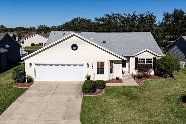 ranch-style house featuring a garage and a front yard