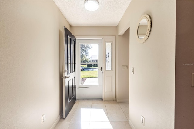 doorway featuring light tile patterned floors and a textured ceiling