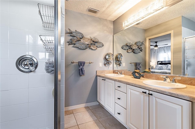 bathroom with vanity, a textured ceiling, tile patterned floors, and ceiling fan