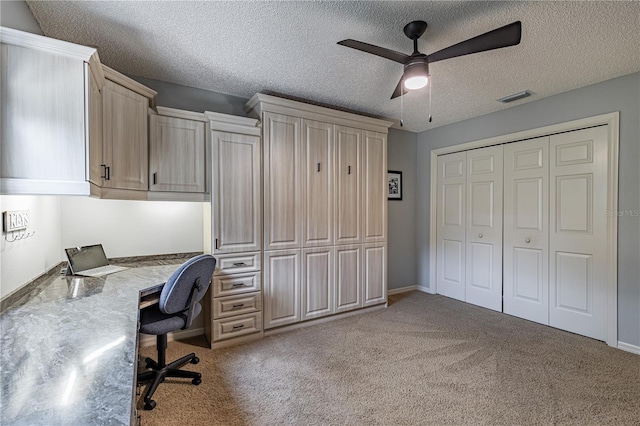 office with ceiling fan, a textured ceiling, and light carpet