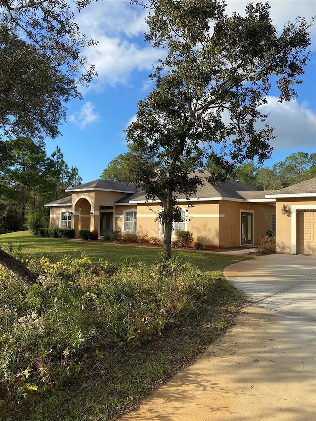 view of front of house with a front yard and a garage