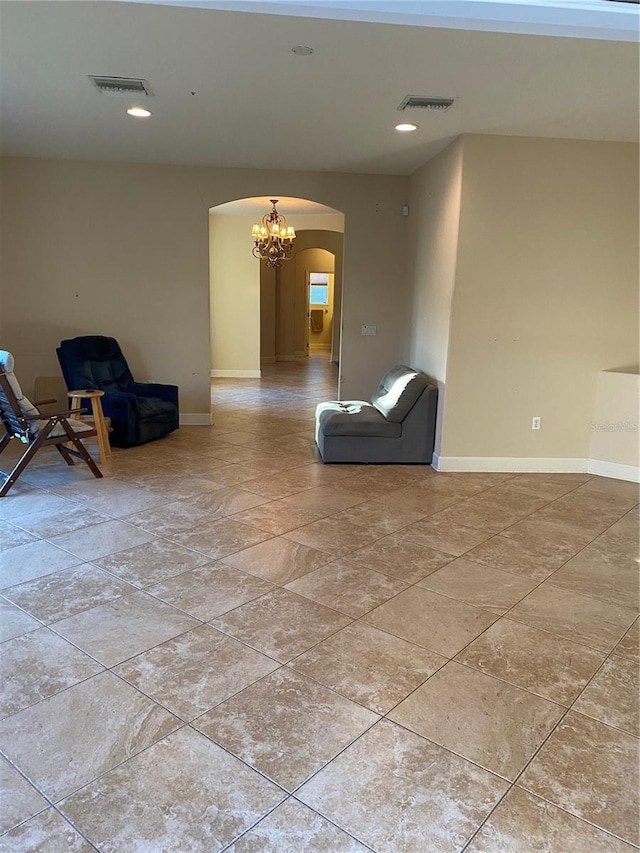 unfurnished room with a notable chandelier