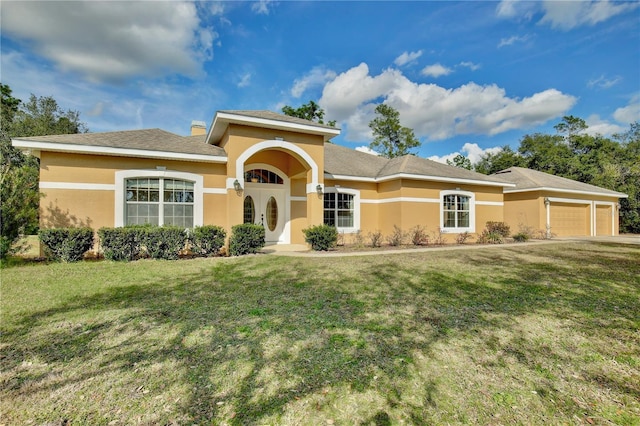 view of front facade with a garage and a front yard