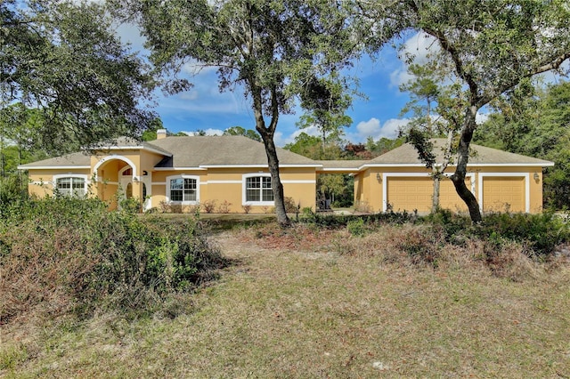 single story home featuring a garage