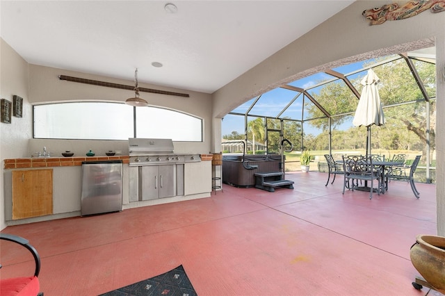 view of patio featuring an outdoor kitchen, sink, glass enclosure, a hot tub, and a grill