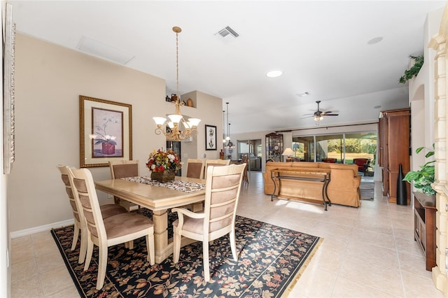 tiled dining space featuring ceiling fan with notable chandelier