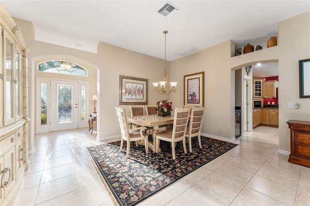 dining room featuring light tile patterned floors and a chandelier