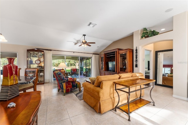 tiled living room featuring ceiling fan and lofted ceiling