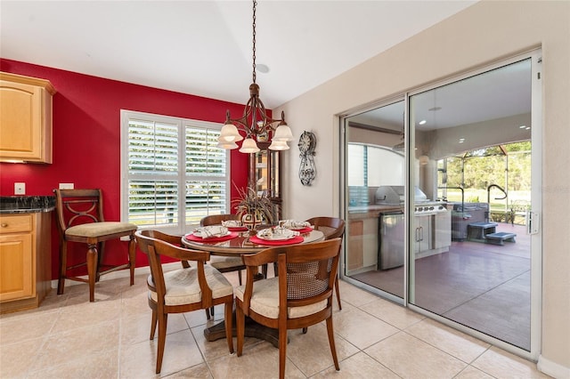 dining room with light tile patterned floors and a notable chandelier