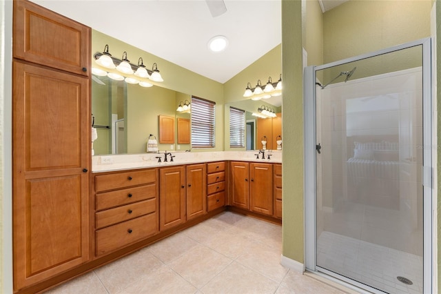 bathroom featuring tile patterned floors, vanity, vaulted ceiling, and an enclosed shower