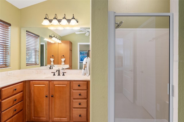 bathroom featuring vanity, vaulted ceiling, an enclosed shower, and ceiling fan