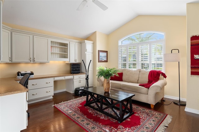 living room featuring built in desk, dark hardwood / wood-style floors, vaulted ceiling, and ceiling fan