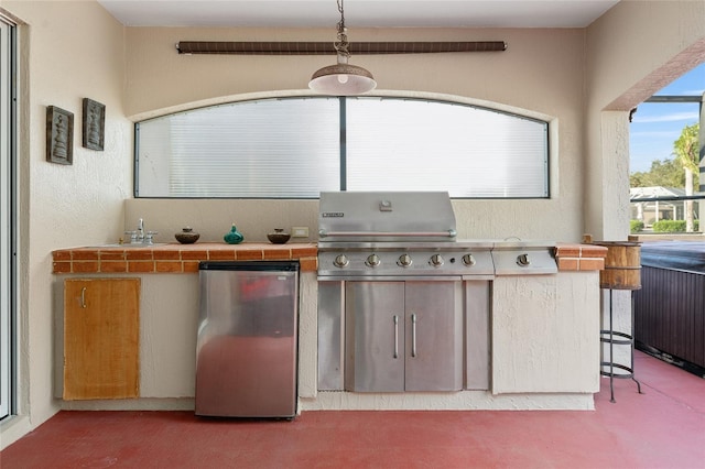 view of patio featuring exterior kitchen, sink, and grilling area