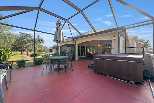 view of patio featuring glass enclosure and a hot tub