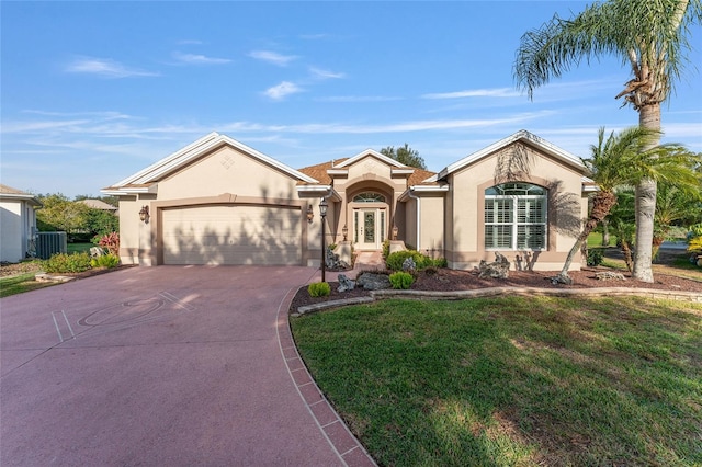 view of front facade with a garage, concrete driveway, french doors, a front lawn, and stucco siding