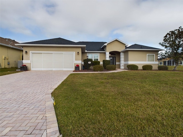 ranch-style house featuring a garage and a front lawn