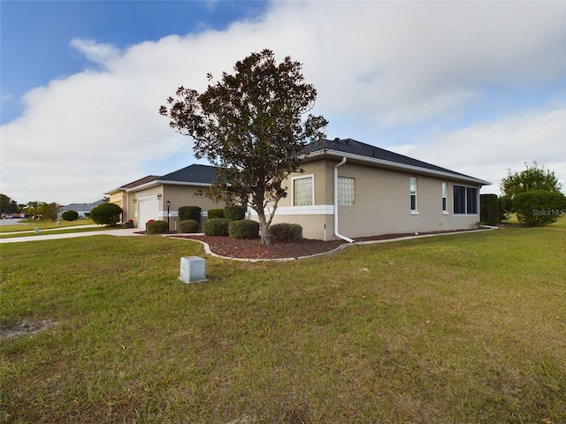 view of home's exterior with a yard and a garage