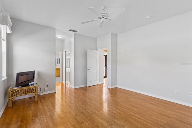 interior space featuring baseboards, light wood-style floors, visible vents, and ceiling fan