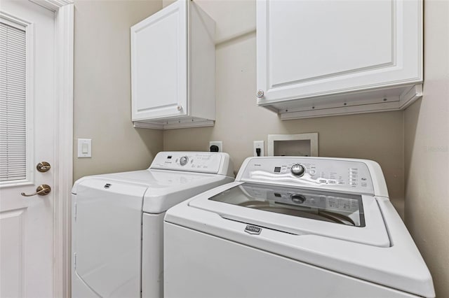 laundry room featuring cabinet space and washing machine and dryer